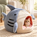 Kitten peeking out of an enclosed warm cat bed