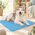 Large dog lying on a pet cooling mat